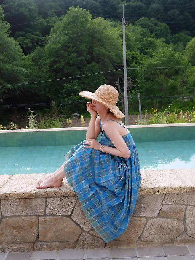Actress Song Hye Kyo has captivated fans with her refreshing vacation routine.On April 4, the actress posted several photos on her social media with the caption, Rest day, photo by mom.In the photos, Song Hye Kyo is wearing a swimsuit and relaxing in the pool. She showed off her natural beauty and sunny mood, attracting attention.In another photo, she wore a checked patterned dress and a straw hat to complete her sensual vacation look. Even in her relaxing vacation outfit, she was able to create a photo-shoot-like atmosphere and stand out.In particular, the photos were reportedly taken by her mother. Song Hye Kyo wrote photo by mom on the post, indicating that it was taken with her mothers affection. Even though the photo is naturally composed, it shows the warm gaze of a family trying to capture their daughters beautiful moments, and fans are responding to it.Meanwhile, Song Hye Kyo is set to premiere her new Netflix original series Slowly and Intensely this year.