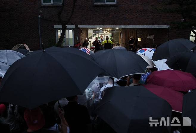[서울=뉴시스] 김진아 기자 = 지난 4일 제9회 전국동시지방선거 투표용지 부족 사태가 발생한 서울 송파구 잠실7동 제2투표소 앞에서 시민들이 투표함 반출을 막으며 구호를 외치고 있다. 2026.06.04. bluesoda@newsis.com