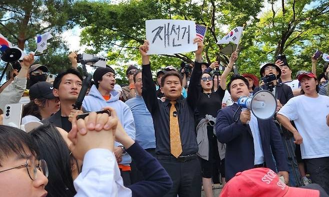 부정선거론을 주장해 온 유튜버 전한길씨와 그라운드시 등이 5일 잠실7동2투표소 투표함 개표가 이뤄진 송파구 올림픽공원 핸드볼경기장에서 지지자들과 항의하고 있다. 장종우 기자