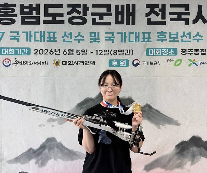 제6회 홍범도장군배 전국사격대회 여자일반부 50m 복사 개인전에서 우승을 차지한 이슬비(경기도청)가 금메달을 걸고 기념사진을 찍고 있다.