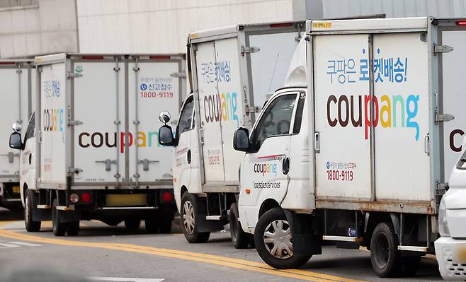 Delivery trucks are parked at a Coupang logistics center in Seoul on Dec. 28, 2025. NEWS1