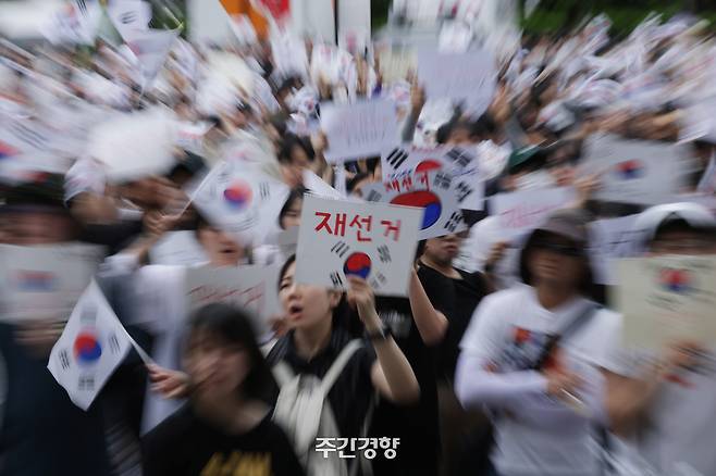 6·3 지방선거에서 일어난 투표용지 부족 사태를 비판하며 재선거를 요구하는 시민들이 6월 7일 서울 송파구 올림픽공원 핸드볼경기장 개표소 앞에 모여 구호를 외치고 있다. 정효진 기자