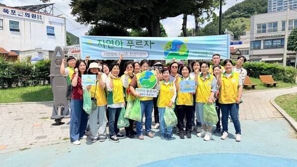 신천지자원봉사단 거제지부가 지난 9일 거제 옥포시장에서 '자연아 푸르자' 환경정화 캠페인을 펼치고 있는 가운데 봉사자들과 기념 촬영을 하고 있다/사진제공= 신천지자원봉사단 거제지부.