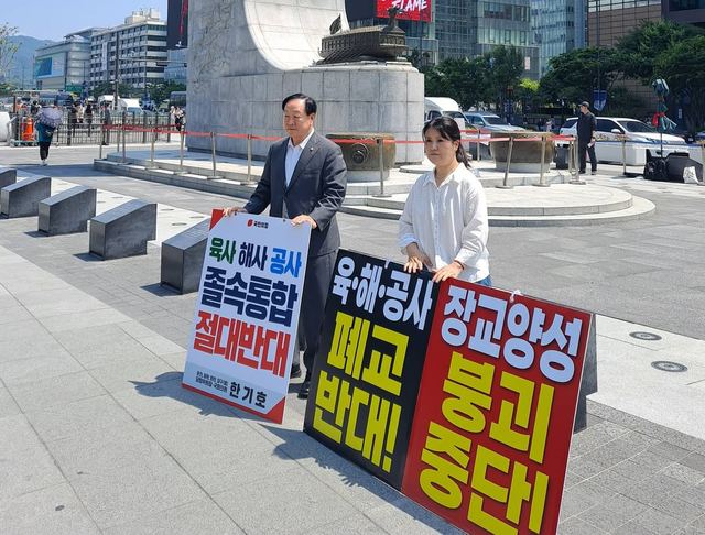 육군 교육사령관 출신 한기호(왼쪽) 국민의힘 의원과 제2연평해전 전사자 고 한상국 상사의 부인 김한나(오른쪽) 사단법인 영웅을위한세상 대표가 지난 6월 12일 서울 광화문광장에서 육·해·공군 사관학교 통폐합 정책에 반대하는 피켓시위 및 길거리 시민투표 등을 전개하고 있다. [김한나 영웅을위한세상 대표 페이스북 사진 갈무리]
