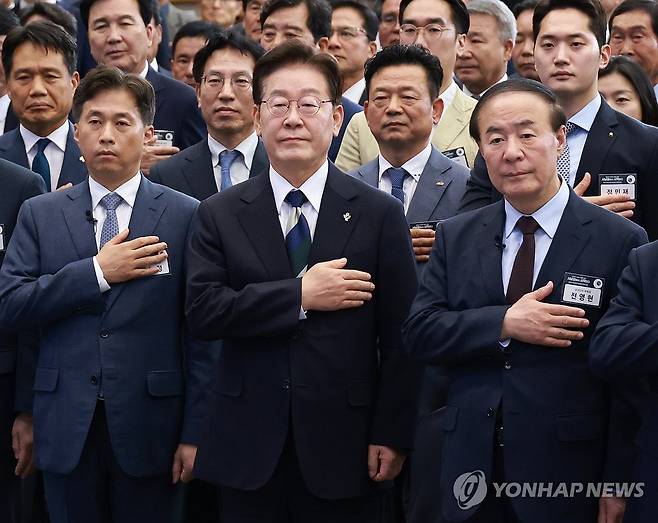 국민의례하는 이재명 대통령 (광주=연합뉴스) 한상균 기자 = 이재명 대통령이 30일 광주 김대중컨벤션센터에서 열린 서남권 첨단산업 발전비전 국민보고회에서 국민의례를 하고 있다. 
    왼쪽부터 곽노정 SK하이닉스 대표, 이재명 대통령, 전영현 삼성전자 부회장. 2026.6.30 xyz@yna.co.kr