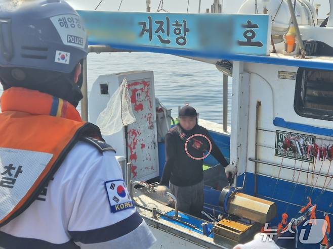 3일 강원 고성군 공현진 해상에서 속초해양경찰서 거진파출소 소속 경찰관인 조업 중인 어선을 상대로 구명조끼 착용 여부를 단속하고 있다. 어민이 벨트형 구명조끼(빨간 원)를 착용한 모습.2026.7.5/뉴스1 윤왕근 기자