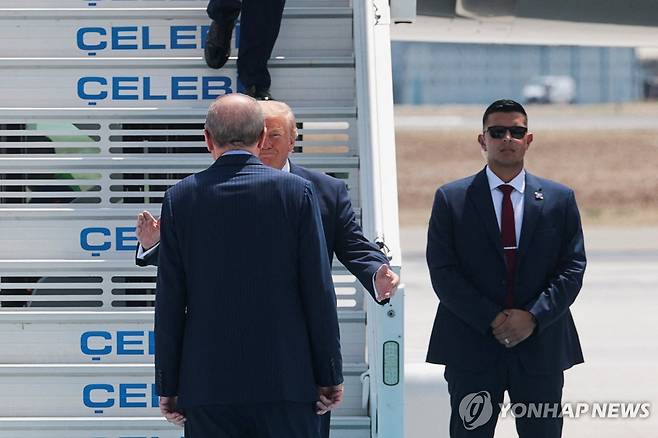 트럼프 미국 대통령을 직접 맞이하는 에르도안 튀르키예 대통령 나토 정상회의 참석차 튀르키예를 방문한 도널드 트럼프 미국 대통령(가운데)이 7일(현지시간) 앙카라 공항에서 마중나온 레제프 타이이프 에르도안 튀르키예 대통령과 인사하고 있다. [로이터=연합뉴스. 재판매 및 DB 금지]