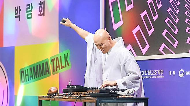 DJ NewJeansNim, the EDM-performing persona of comedian Yoon Sung-ho, performs at the 2024 Seoul International Buddishm Expo. SEOUL INTERNATIONAL BUDDHISM EXPO