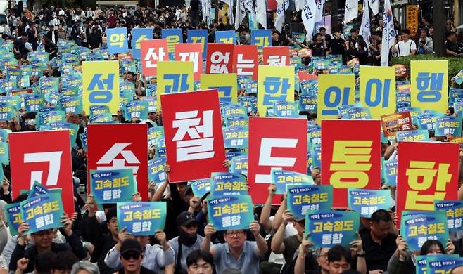 지난해 10월 서울 용산구 삼각지역 인근에서 열린 철도 노동자 총력결의대회에서 참가자들이 고속철도(KTX-SRT) 통합 등을 촉구하며 손팻말을 들고 있다. 연합뉴스