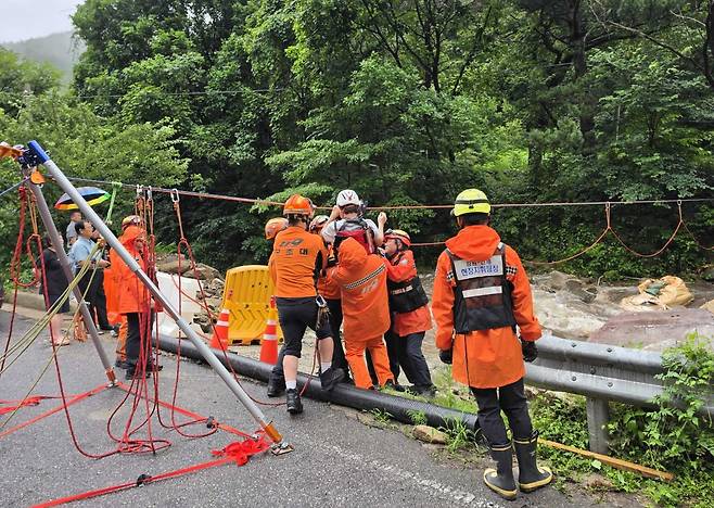 Emergency authorities attempt to rescue residents stranded by heavy rain in Inje County, Gangwon, on July 18. GANGWON STATE FIRE HEADQUARTERS