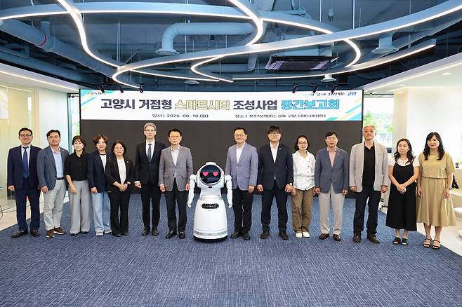 민경선 고양특례시장과 AI 로봇 사회자 '고양ON'을 비롯한 중간보고회 참석자들이 기념촬영을 하고 있다. 사진=고양시청