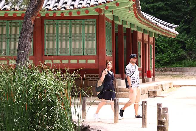 Foreign tourists walk inside the Jongmyo Shrine in Jongno District, central Seoul, on July 13. YONHAP