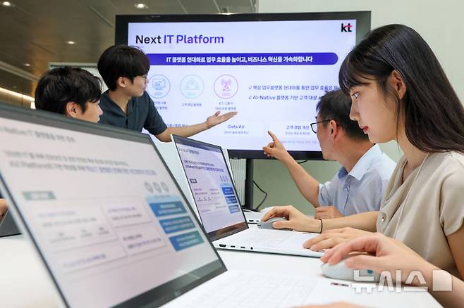 [서울=뉴시스]KT가 정보보호와 서비스 안정성을 강화하고 'AX 플랫폼 컴퍼니' 전략의 실행 기반을 마련하기 위한 전사 IT 현대화에 속도를 내고 있다고 24일 밝혔다. 사진은 KT 직원들이 넥스트 IT 플랫폼 기반의 핵심 업무 플랫폼 현대화 방향에 대해 논의하는 모습. (사진=KT 제공)