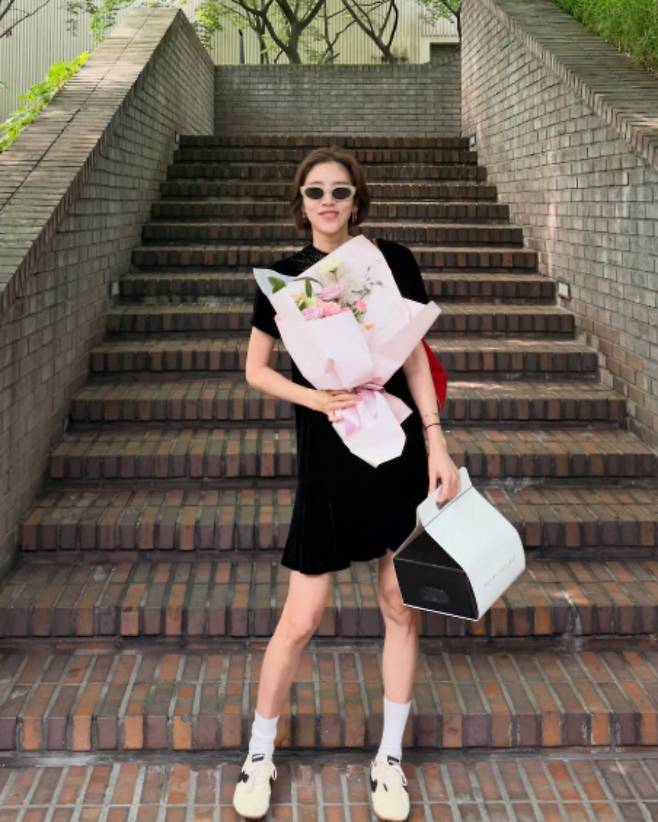 Singer and actress Son Dam-bi expressed her gratitude while showing off the birthday eve celebration prepared by her husband, Lee Kyu-hyuk.On the 23rd, Son Dam-bi posted several photos on her personal channel along with the caption, Is it okay to be this happy right from the birthday eve?In the photos, Son Dam-bi is seen smiling brightly while holding a large bouquet of flowers, which appears to have been a gift from her husband, Lee Kyu-hyuk.Matching a black mini dress with sunglasses, Son Dam-bi completed a sophisticated look, revealing her slender legs. In another photo, she showed off their still-sweet marital relationship by leaning her face close to Lee Kyu-hyuks and pouting her lips.In particular, Son Dam-bi expressed her gratitude to Lee Kyu-hyuk for pouring his heart into preparing for her starting the day before her birthday.She stated, From the restaurant he chose for me to the flowers and the cake. Seeing the thoughtfulness my husband put into preparing every single detail, this years birthday was touching right from the start.She continued, It has already been five years since we started celebrating birthdays together. In the meantime, Hae-yi joined us, so now the three of us are blowing out the candles together, expressing her affection for her family. Today, being able to smile and say thank you to each other with the two people I love the most—I will remember this warmth for a long, long time.Finally, Son Dam-bi cheerfully added to Lee Kyu-hyuk, Honey, thank you. Please do the birthday eve party again next year, expressing her satisfaction with her husbands surprise.Meanwhile, Son Dam-bi married former national speed skating team member Lee Kyu-hyuk in 2022 and welcomed a daughter last April.Photo = Son Dam-bi