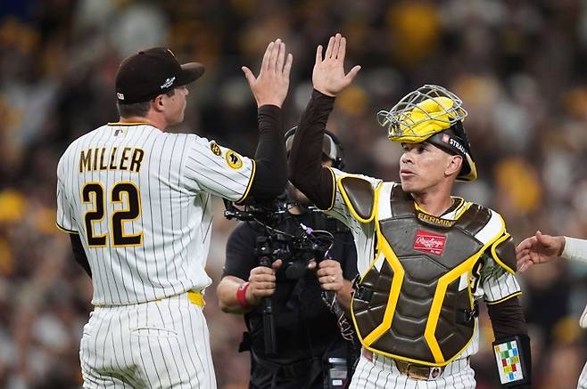 Cubs Padres BaseballSan Diego Padres catcher Freddy Fermin celebrates with pitcher Mason Miller (22) after defeating the Chicago Cubs in Game 2 of the National League Wild Card baseball playoff series Wednesday, Sept. 30, 2026, in San Diego. (AP Photo/Gregory Bull)