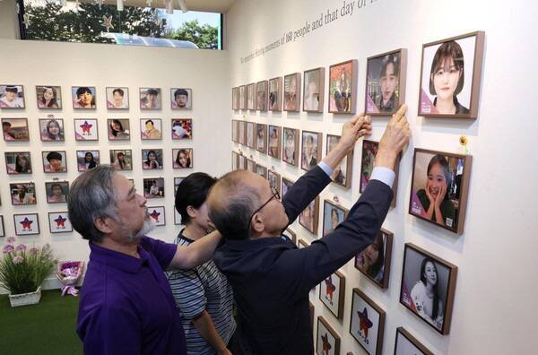 지난 1일 서울 종로구 적선현대빌딩에 마련된 별들의 집에서 열린 10.29 이태원 참사 4주기 '기억과 애도의 날' 선포 기자회견에서 160번째 희생자 고 백형준 님 가족이 고인의 사진 액자를 걸고 있다./연합뉴스