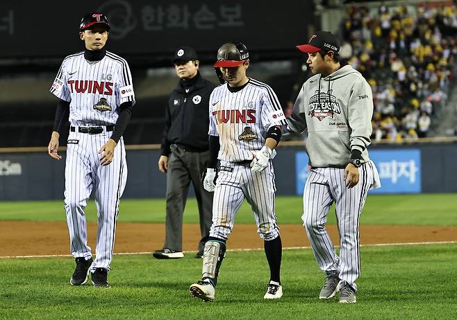 14일 서울 잠실야구장에서 열린 2026 신한 SOL KBO 포스트시즌 와일드카드 결정전 1차전 두산 베어스와 LG 트윈스의 경기. 8회말 1사 1, 3루 LG 신민재가 스퀴즈 번트 성공 후 통증을 호소하며 교체되고 있다. 연합뉴스