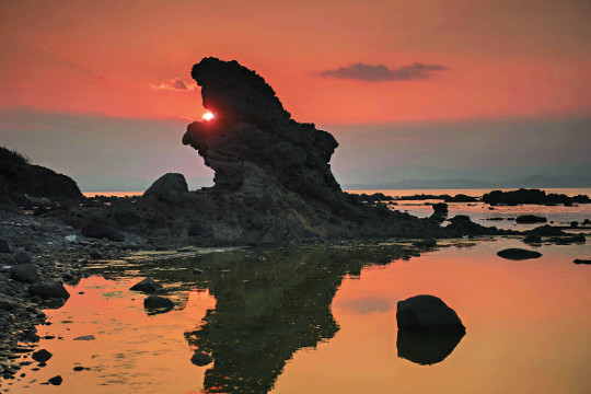 석양이 아름다운 호미곶 까꾸리계 앞바다에 웅크리고 앉아 바다를 굽어보는 모습의 독수리 바위가 해를 삼키고 하늘로 비상할 것처럼 보인다.
