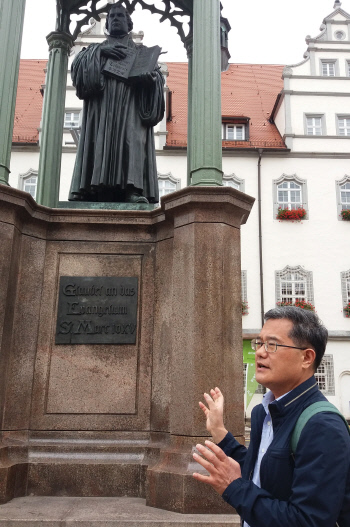 비텐베르크 시청 광장의 루터기념상 앞에서 김덕영 카셀대 교수가 종교개혁의 의미를 설명하고 있다.