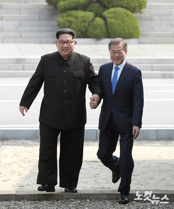 문재인 대통령이 27일 판문점에서 김정은 국무위원장의 깜짝 제안으로 잠시 북측으로 월경한 뒤 함께 남측으로 넘어오고 있다. (사진=한국공동사진기자단)