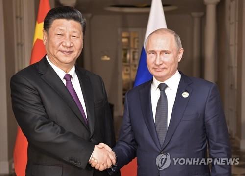 악수하는 시진핑(왼쪽)과 푸틴[연합뉴스 자료사진]
