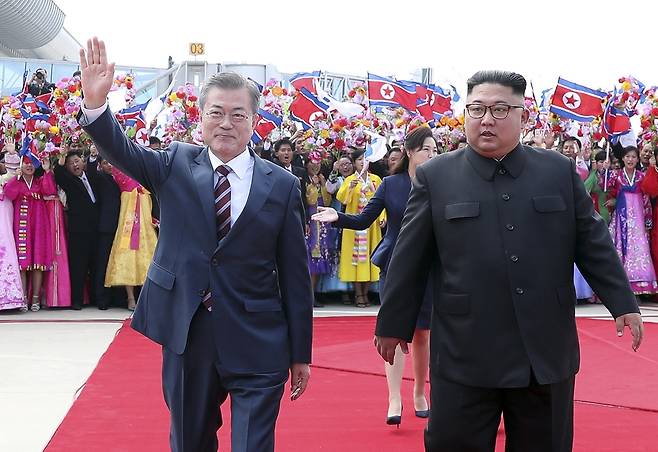 문재인 대통령과 김정은 국무위원장이 18일 오전 평양 순안공항에서 열린 공식 환영식에서 평양 시민들의 환영을 받으며 이동하고 있다. 평양사진공동취재단