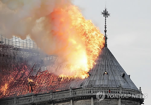 불길에 타들어가는 노트르담 대성당 지붕 (파리 EPA=연합뉴스) 프랑스 파리의 상징으로 최대 관광명소의 하나인 노트르담 대성당의 지붕이 지난 15일(현지시간) 발생한 대형 화재로 불길에 휩싸여 타고 있다. ymarshal@yna.co.kr