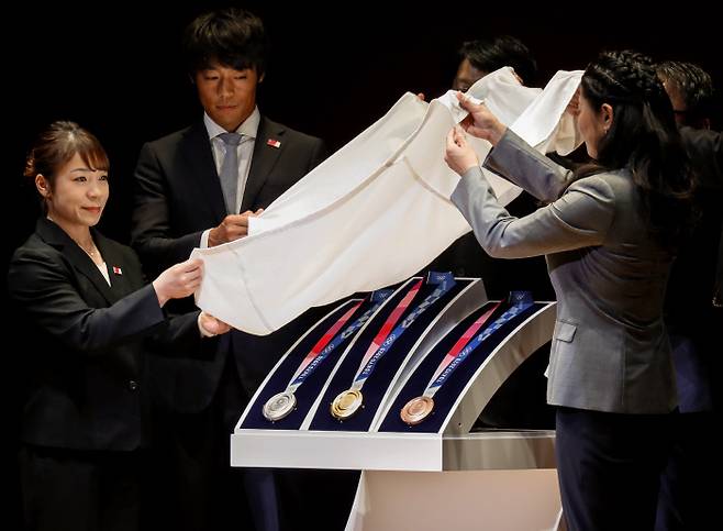 2020 도쿄 올림픽 개막을 1년 앞두고 지난 24일 일본 도쿄포럼에서 열린 기념행사 도중 올림픽 메달이 공개되고 있다. 도쿄 | EPA연합뉴스