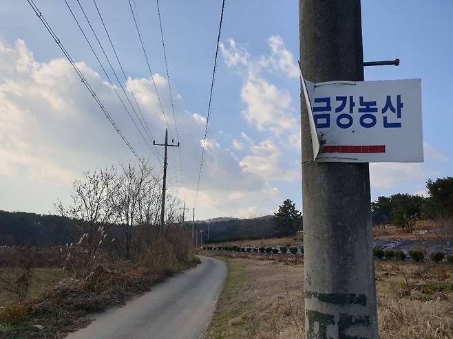 금강농산으로 들어가는 길목 전봇대에 붙은 공장 표지판. 익산=김준희 기자