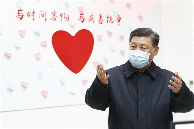 시진핑 중국 국가주석이 10일 중국 수도 베이징의 질병통제예방센터를 방문해 관계자들과 얘기를 나누고 있다. 뒷면 벽에 ‘시간과의 싸움, 바이러스와의 전쟁’이라고 적혀 있다. 베이징=신화 뉴시스