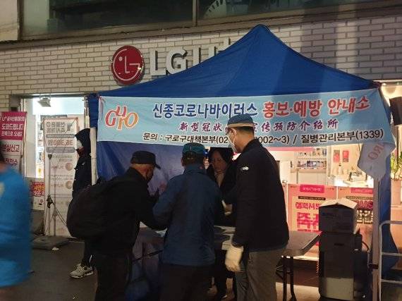 새벽 시간 일거리를 찾아 나온 일용직 근로자들을 상대로 코로나19 예방수칙을 전하는 구로구 관계자들. 중국인 근로자들이 많이 찾는 곳인 만큼 한자로 된 현수막과 안내책자 등을 이용해 방역 수칙을 알리고 있다. / 사진=최재성 기자