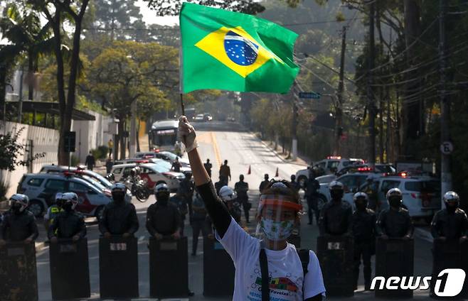 18일(현지시간) 브라질 상파울루에서 한 시민이 보건당국에 코로나19 관련 지원을 요구하는 시위를 벌이고 있다. © AFP=뉴스1