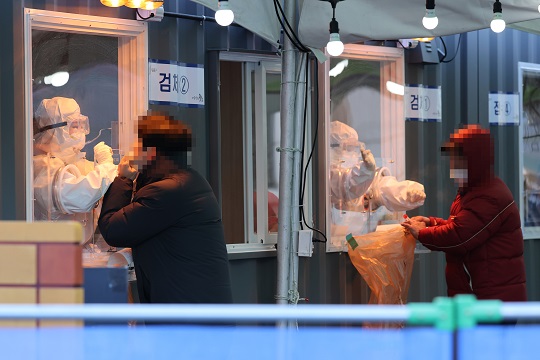 서울역 앞에 마련된 임시선별진료소에서 의료진이 검체채취를 하고 있다. 연합뉴스
