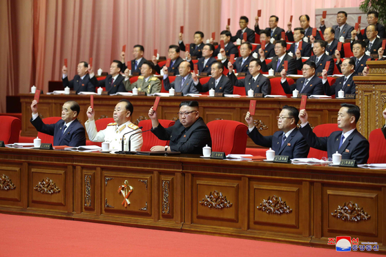 North Korean leader Kim Jong-un, third from left, and other top officials hold up their Workers' Party certificates on the fifth day of the 8th Party Congress on Saturday, in this state media photograph from Sunday. [YONHAP]