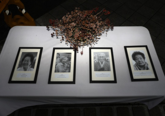 On January 10, the funeral portraits of the deceased comfort women victims are placed next to the “Girl of Peace” statue in front of the former Japanese Embassy in Jongno-gu, Seoul. Kwon Do-hyun
