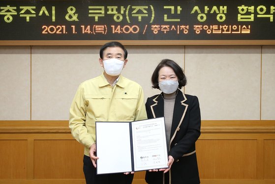 조길형(왼쪽) 충주시장과 윤혜영 쿠팡 리테일 부사장이 14일 충주시청에서 업무협약을 체결하고 있다.