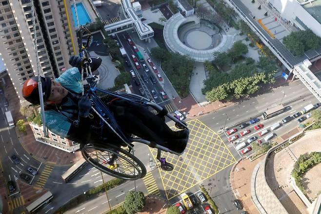 지난 16일 (현지 시각) 휠체어에 탄 채 320m 높이의 홍콩 니나타워를 등반하는 라이 치와이. /로이터 연합뉴스