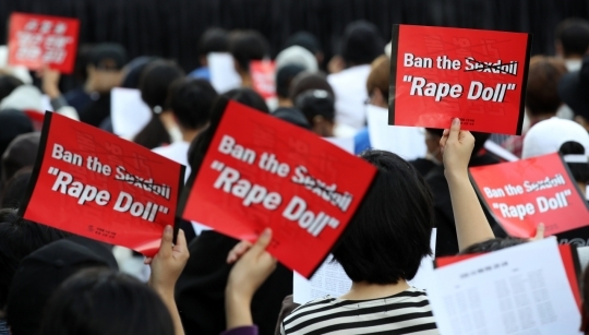 Demonstraters hold up placards saying “Rape Doll” at a rally protesting the import of life-size sex dolls. The rally was held near Cheonggye Stream in central Seoul in September 2019. (Yonhap)