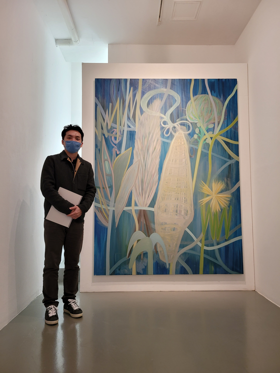 Artist Park Jin-hee poses with his painting ″Marsh Garden″ which is part of the ″On-Tact″ show at K.O.N.G Gallery in central Seoul. [MOON SO-YOUNG]