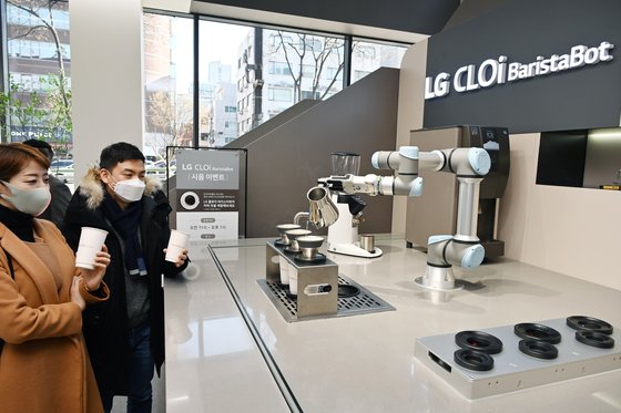 LG 베스트샵 서초본점을 방문한 고객들이 LG 클로이 바리스타봇이 핸드드립 방식으로 만든 커피를 즐기고 있다. LG전자 제공
