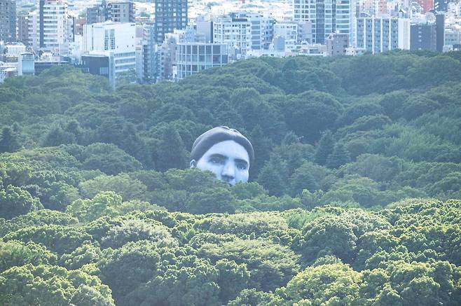 ‘꿈이 현실에서 이루어진다’는 의미의 공공미술 열기구 ‘마사유메’(正夢)가 16일 일본 도쿄 요요기공원 나무숲 사이로 떠오르고 있다. AFP=연합뉴스