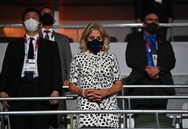 조 바이든 미국 대통령의 부인 질 바이든 여사가 23일 도쿄 올림픽 개막식에 참석해 묵념을 하고 있다. 이날 입은 물방울 무늬 드레스는 지난달 주요7개국(G7) 정상회의 당시 입었던 옷이다. /로이터 연합뉴스