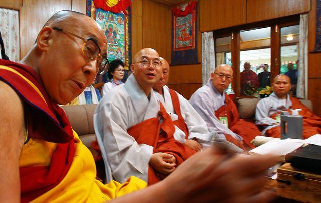 티베트의 정신적 지도자 달라이 라마(왼쪽)가 2016년 8월 인도 다람살라의 '달라이 라마궁'에서 한국 방문 추진위원회로부터 초청장을 전달받아 읽어보고 있다. 다람살라=공동취재단 연합뉴스
