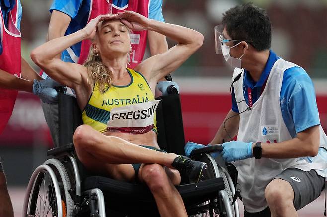 호주의 제네비브 그렉슨이 4일 도쿄올림픽 여자 3000m 장애물 경기에서 아킬레스건 부상을 당해 휠체어에 옮겨진 뒤 좌절하고 있다. EPA연합뉴스