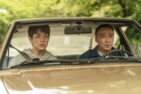 Joon-kyung's father Tae-yoon (played by actor Lee Sung-min), the driver who operates the very train that always passes the village, scoffs at the idea of building a train station in his village. [LOTTE ENTERTAINMENT]