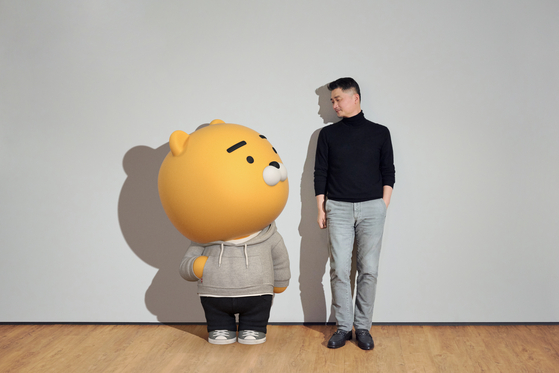 Kakao founder Kim Beom-su, right, with the Ryan character created by Kakao Friends [KAKAO]