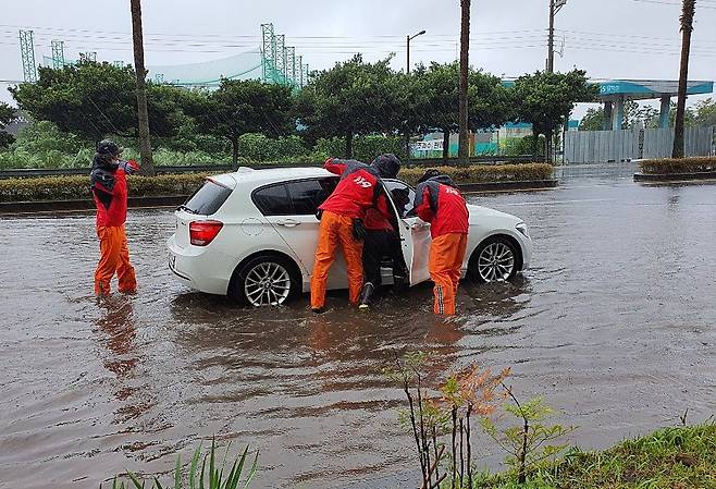 태풍 찬투 영향으로 많은 비가 내린 14일 오전 제주 서귀포시 호근동 수모루사거리 인근 도로에서 119구조대가 차량에 고립된 시민을 구조하고 있다./서귀포소방서