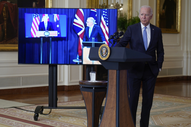 조 바이든 미국 대통령이 지난 15일(현지시간) 백악관 이스트룸에서 보리스 존슨 영국 총리(화면 왼쪽)과 스콧 모리슨 호주 총리(화면 오른쪽)과 국가안보 구상에 관한 화상 회의에 참석하고 있다./AP연합뉴스