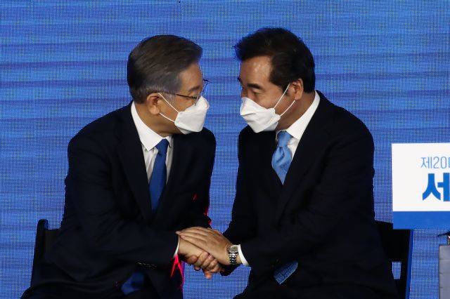 10일 오후 서울 송파구 올림픽공원 SK올림픽핸드볼경기장에서 열린 제20대 대통령선거 후보자 선출을 위한 서울 합동연설회에서 대선 후보로 확정된 이재명 경기도지사가 이낙연 후보와 손을 잡고 대화하고 있다. 국회사진기자단