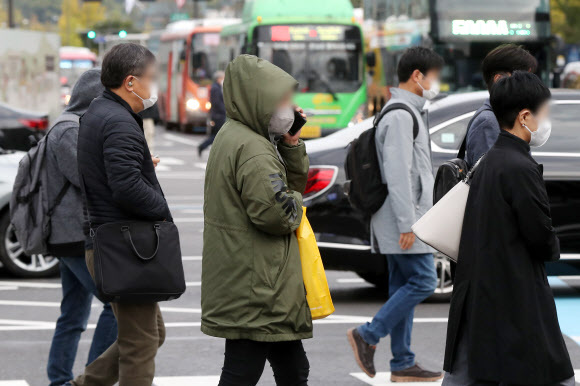 18일 오전 서울 종로구 광화문 네거리에서 두꺼운 겨울옷을 챙겨 입은 시민들이 출근길 발걸음을 재촉하고 있다. 뉴스1